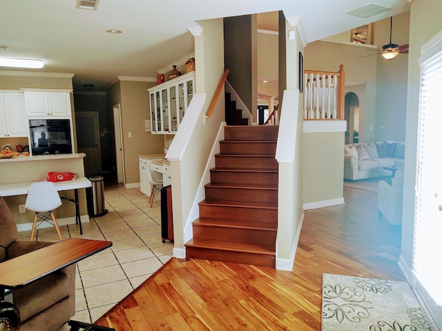 197 Walnut Gardens Dr, Memphis, TN 38018 - stairway featuring arched walkways, crown molding, wood finished floors, and baseboards