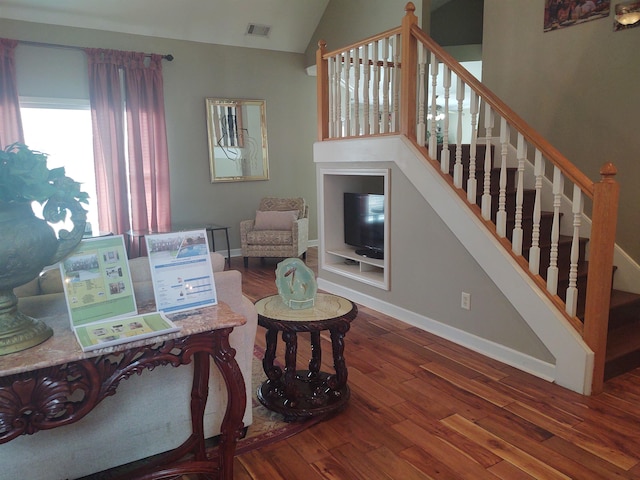 197 Walnut Gardens Dr, Memphis, TN 38018 - living area featuring hardwood / wood-style flooring, vaulted ceiling, baseboards, and stairway
