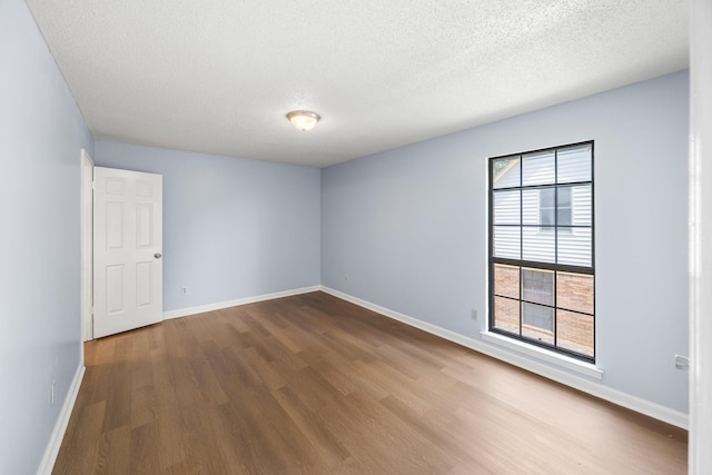 5424 Peyton Randolph St, Bartlett, TN 38134 - unfurnished room featuring dark wood finished floors, a textured ceiling, and baseboards