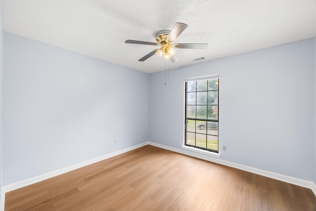 5424 Peyton Randolph St, Bartlett, TN 38134 - empty room with wood finished floors, baseboards, a ceiling fan, and a textured ceiling