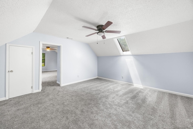 5424 Peyton Randolph St, Bartlett, TN 38134 - additional living space with a ceiling fan, carpet floors, vaulted ceiling, a skylight, and a textured ceiling