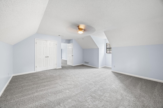 5424 Peyton Randolph St, Bartlett, TN 38134 - additional living space featuring carpet, vaulted ceiling, a textured ceiling, baseboards, and a ceiling fan
