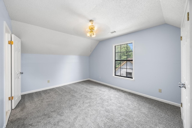5424 Peyton Randolph St, Bartlett, TN 38134 - additional living space featuring lofted ceiling, carpet floors, baseboards, and a textured ceiling