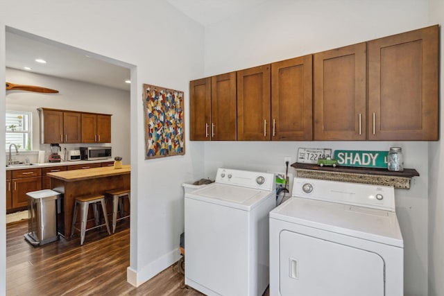 2106 Higbee Ave, Memphis, TN 38104 - laundry room with washing machine and clothes dryer, dark wood-type flooring, baseboards, recessed lighting, and cabinet space