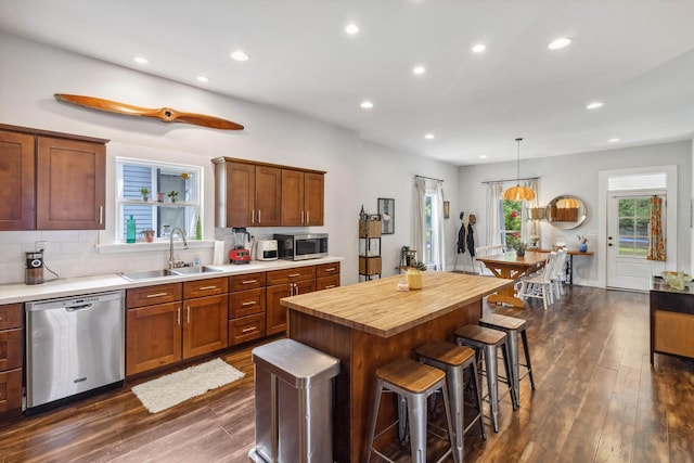 2106 Higbee Ave, Memphis, TN 38104 - kitchen with stainless steel appliances, a sink, dark wood-type flooring, butcher block countertops, and recessed lighting