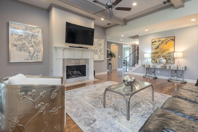 12432 Zapata Cv, Collierville, TN 38017 - living room featuring ceiling fan, beam ceiling, wood finished floors, stairway, and a fireplace