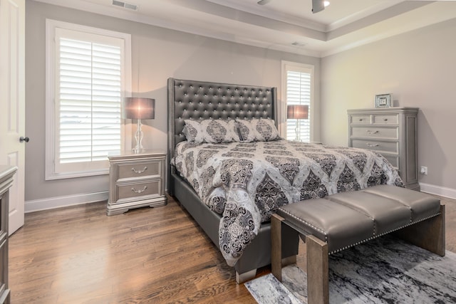 12432 Zapata Cv, Collierville, TN 38017 - bedroom featuring wood finished floors, ornamental molding, baseboards, and a raised ceiling