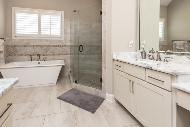 12432 Zapata Cv, Collierville, TN 38017 - full bathroom with vanity, a stall shower, and a freestanding tub