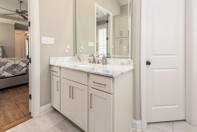 12432 Zapata Cv, Collierville, TN 38017 - ensuite bathroom featuring vanity, a ceiling fan, baseboards, and tile patterned flooring