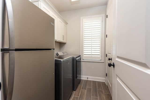 12432 Zapata Cv, Collierville, TN 38017 - washroom featuring cabinet space, washer and clothes dryer, baseboards, and wood tiled floors