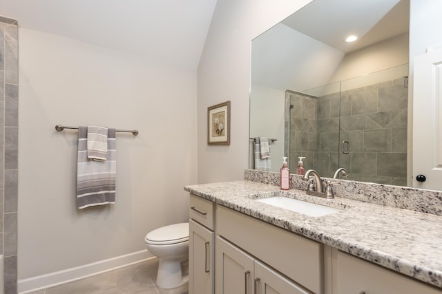 12432 Zapata Cv, Collierville, TN 38017 - bathroom featuring lofted ceiling, vanity, toilet, baseboards, and a stall shower