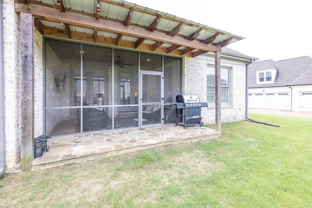 12432 Zapata Cv, Collierville, TN 38017 - rear view of house with a sunroom, a yard, brick siding, and a ceiling fan