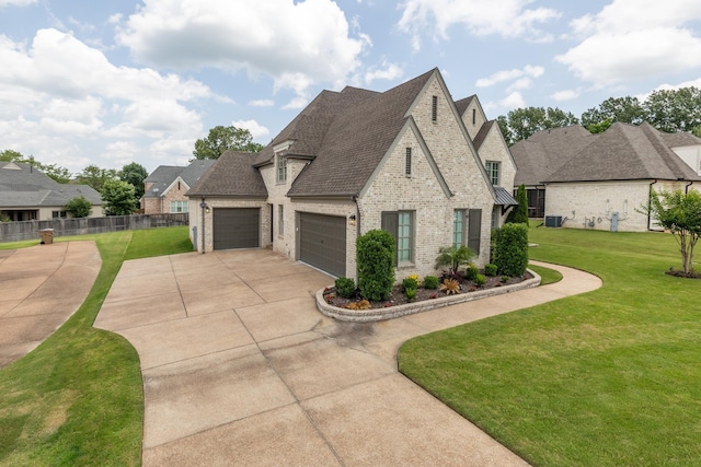 12432 Zapata Cv, Collierville, TN 38017 - french country inspired facade featuring brick siding, concrete driveway, a garage, and a shingled roof