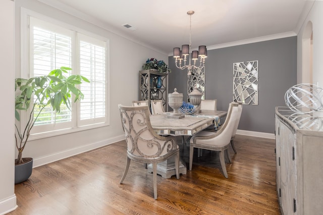 12432 Zapata Cv, Collierville, TN 38017 - dining area with a chandelier, baseboards, crown molding, and wood finished floors