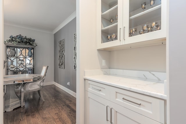 12432 Zapata Cv, Collierville, TN 38017 - dining room featuring crown molding, dark wood-type flooring, and baseboards
