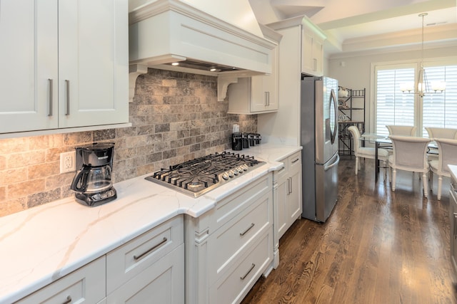 12432 Zapata Cv, Collierville, TN 38017 - kitchen with stainless steel appliances, custom range hood, a chandelier, backsplash, and dark wood finished floors