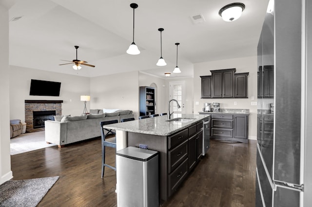 6486 Anglia Valley Dr, Arlington, TN 38002 - kitchen featuring a sink, a ceiling fan, dark wood-style floors, and a kitchen breakfast bar