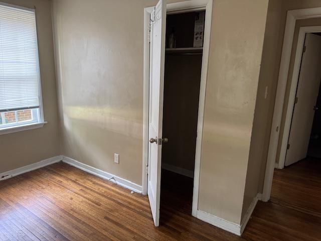 1245 Holliday Ave, Memphis, TN 38122 - unfurnished bedroom featuring wood finished floors, baseboards, and a closet