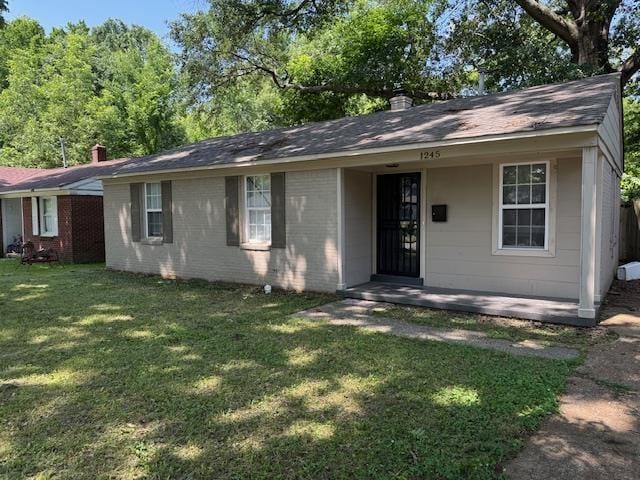 1245 Holliday Ave, Memphis, TN 38122 - ranch-style home featuring a front yard, brick siding, a shingled roof, and a chimney