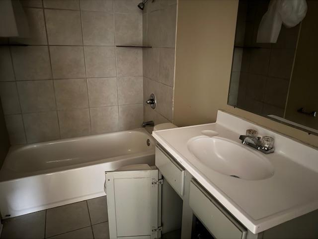 1245 Holliday Ave, Memphis, TN 38122 - bathroom featuring vanity, shower / bath combination, tile patterned flooring, and toilet