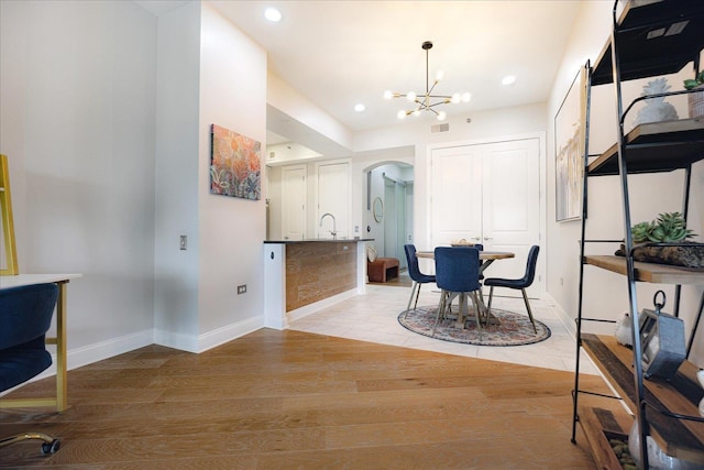 717 Riverside Dr Unit 1104, Memphis, TN 38103 - office area with a chandelier, arched walkways, baseboards, light wood-style flooring, and a sink