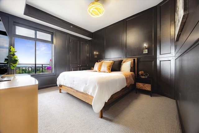 717 Riverside Dr Unit 1104, Memphis, TN 38103 - bedroom featuring a decorative wall and light carpet