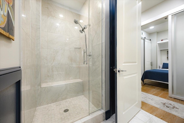 717 Riverside Dr Unit 1104, Memphis, TN 38103 - ensuite bathroom with a shower stall and wood finished floors