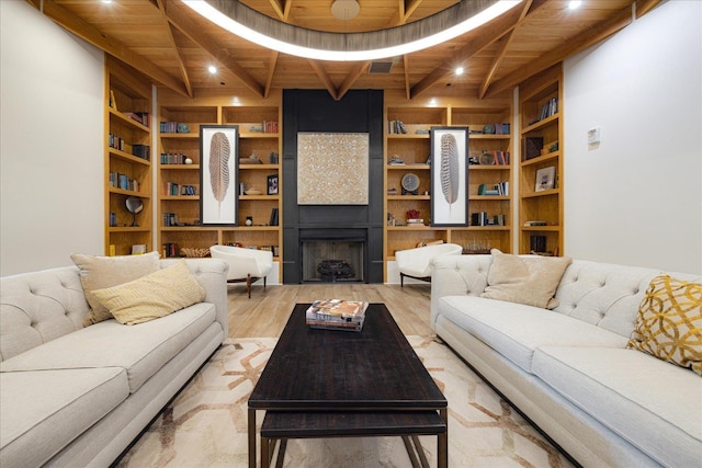 717 Riverside Dr Unit 1104, Memphis, TN 38103 - living room featuring wood ceiling with exposed beams, built in features, light wood-type flooring, recessed lighting, and a large fireplace