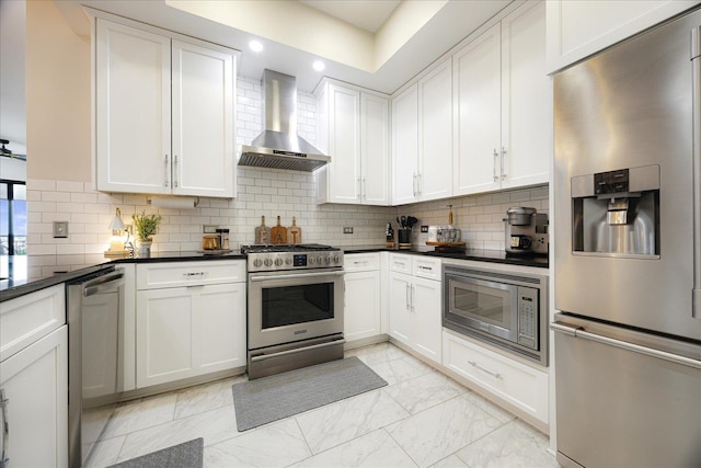 717 Riverside Dr Unit 1104, Memphis, TN 38103 - kitchen with stainless steel appliances, wall chimney exhaust hood, dark countertops, backsplash, and white cabinetry