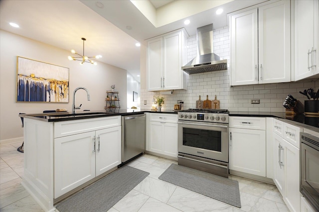 717 Riverside Dr Unit 1104, Memphis, TN 38103 - kitchen with wall chimney range hood, stainless steel appliances, light marble finish floors, a peninsula, and tasteful backsplash