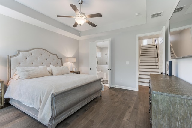 9709 Woodland Brook Ln S, Cordova, TN 38018 - bedroom with dark wood-style floors, a tray ceiling, baseboards, ensuite bathroom, and ceiling fan