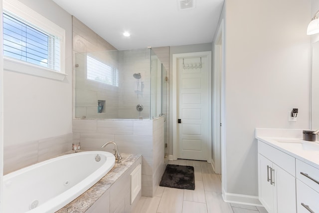 9709 Woodland Brook Ln S, Cordova, TN 38018 - full bathroom featuring a shower stall, a whirlpool tub, vanity, tile patterned floors, and baseboards