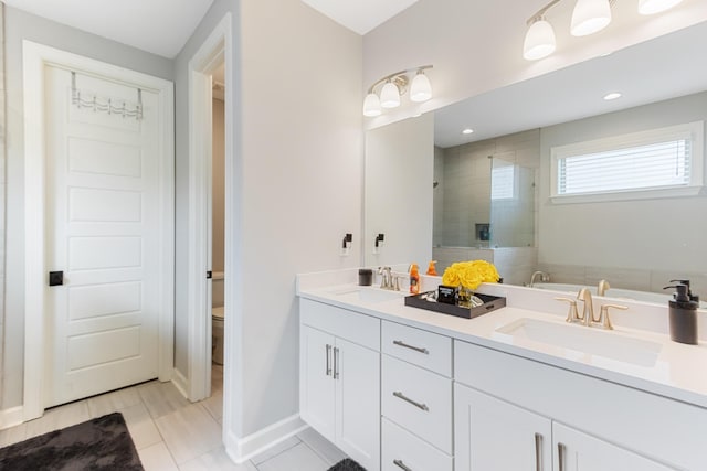 9709 Woodland Brook Ln S, Cordova, TN 38018 - bathroom featuring a stall shower, double vanity, toilet, baseboards, and tile patterned flooring