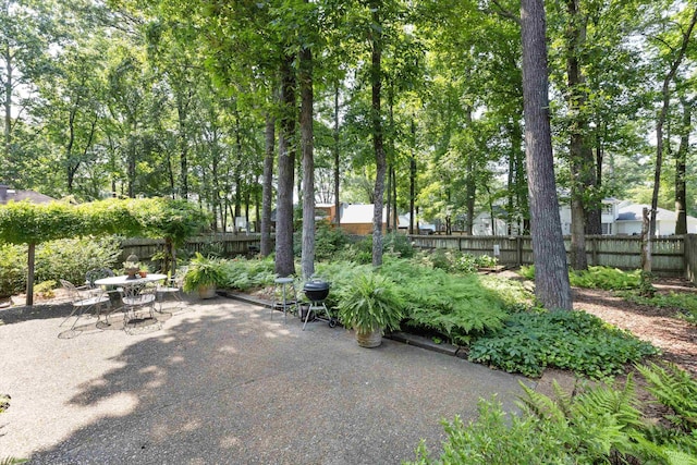 8741 Montavesta Dr, Germantown, TN 38139 - fenced backyard with a patio and outdoor dining area