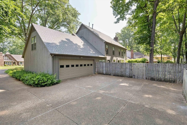 8741 Montavesta Dr, Germantown, TN 38139 - view of property exterior with roof with shingles, a garage, and concrete driveway