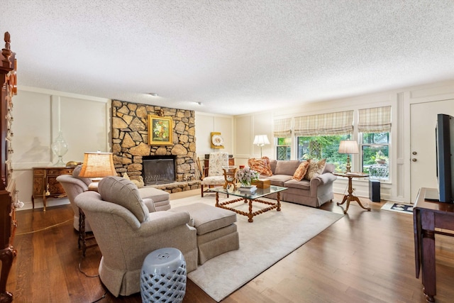 8741 Montavesta Dr, Germantown, TN 38139 - living room with a textured ceiling, dark wood-style floors, a fireplace, and ornamental molding