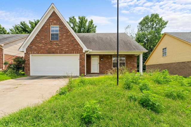 321 Switchgrass Cv, Munford, TN 38058 - view of front facade with brick siding, driveway, and a shingled roof