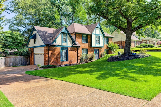 9040 Ashmere Dr, Germantown, TN 38139 - tudor home featuring brick siding, a garage, and concrete driveway