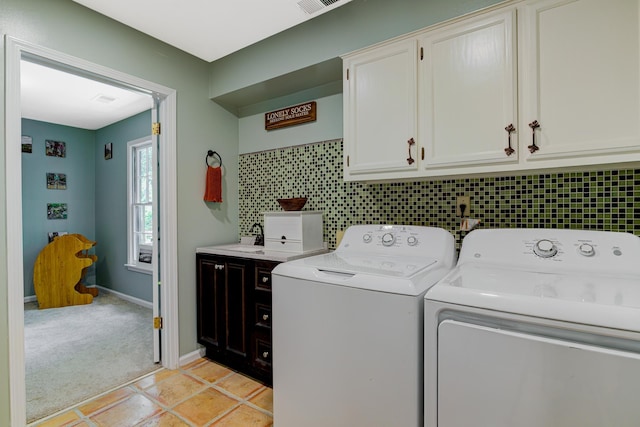 9040 Ashmere Dr, Germantown, TN 38139 - laundry area featuring separate washer and dryer, cabinet space, baseboards, and light carpet