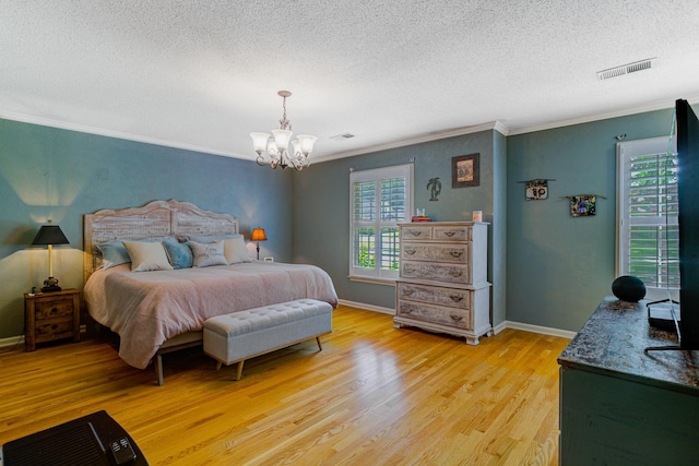 9040 Ashmere Dr, Germantown, TN 38139 - bedroom with ornamental molding, light wood-style flooring, a textured ceiling, a chandelier, and baseboards