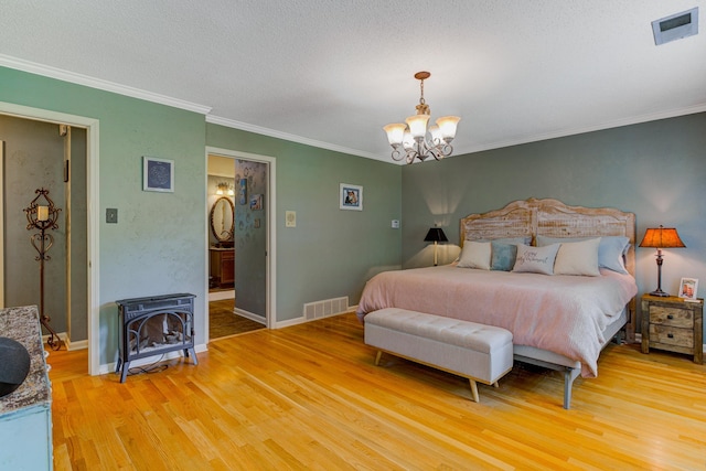 9040 Ashmere Dr, Germantown, TN 38139 - bedroom with a chandelier, light wood finished floors, ornamental molding, a wood stove, and baseboards