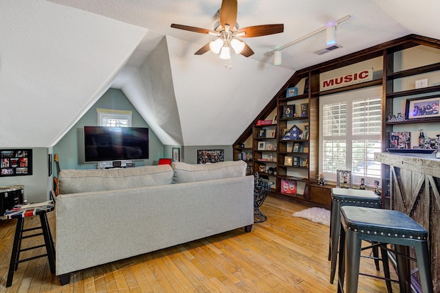 9040 Ashmere Dr, Germantown, TN 38139 - living area featuring wood-type flooring, a ceiling fan, healthy amount of natural light, and lofted ceiling