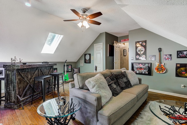 9040 Ashmere Dr, Germantown, TN 38139 - living area featuring vaulted ceiling, a ceiling fan, wood-type flooring, baseboards, and a textured ceiling
