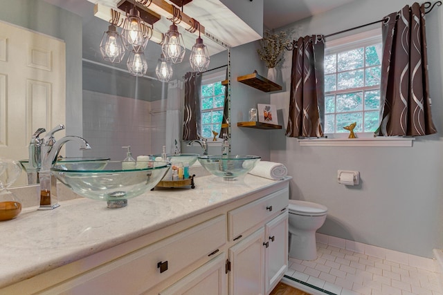 9040 Ashmere Dr, Germantown, TN 38139 - bathroom featuring double vanity, toilet, tile patterned flooring, and baseboards