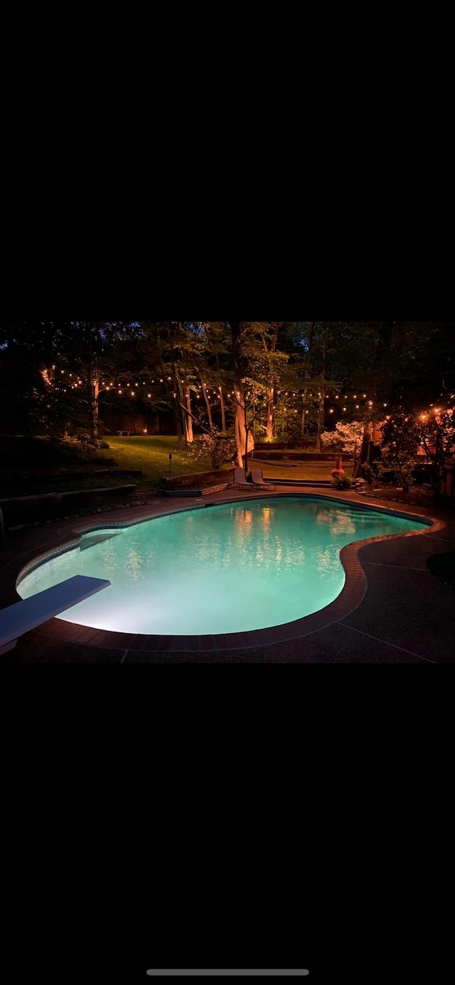 9040 Ashmere Dr, Germantown, TN 38139 - pool at night with an outdoor pool and a diving board