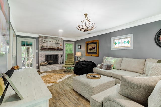 9040 Ashmere Dr, Germantown, TN 38139 - living area featuring crown molding, a chandelier, wood finished floors, and a fireplace