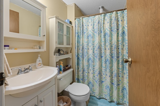 6814 Azalea Hill Cv, Bartlett, TN 38135 - bathroom with a textured ceiling, vanity, toilet, and curtained shower