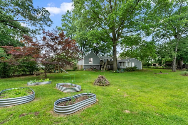 6814 Azalea Hill Cv, Bartlett, TN 38135 - view of green lawn featuring a garden and a playground