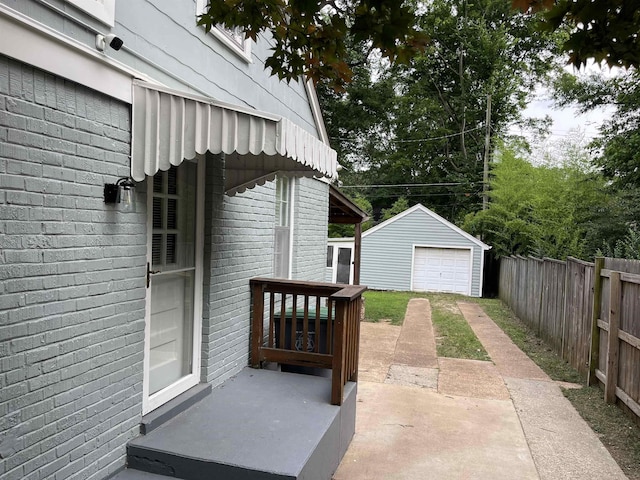 3529 Johnwood Dr, Memphis, TN 38122 - view of patio with driveway, a detached garage, and an outbuilding