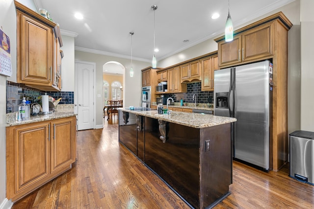 1073 Woodland Glen Dr, Cordova, TN 38018 - kitchen with appliances with stainless steel finishes, arched walkways, backsplash, dark wood finished floors, and crown molding